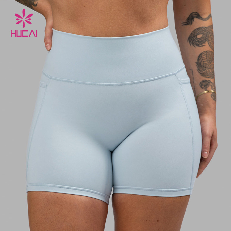 Compression-lined training shorts with panel seams and a wide high-rise waistband shown on a model