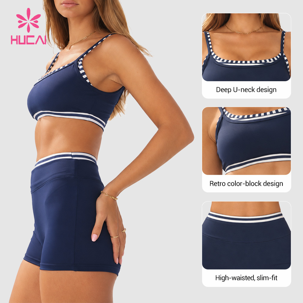 Deep U-neckline and retro colour-block trim detail on a custom navy workout set