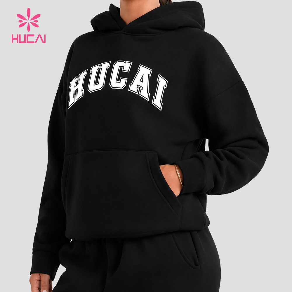 Black oversized pullover hoodie three-quarter view with dropped shoulder seam and kangaroo pocket