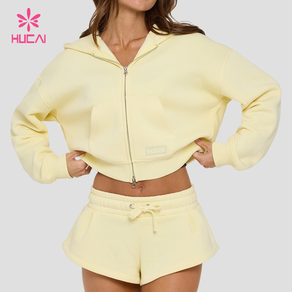 Butter yellow cropped zip-through hoodie with front patch pockets and woven patch label