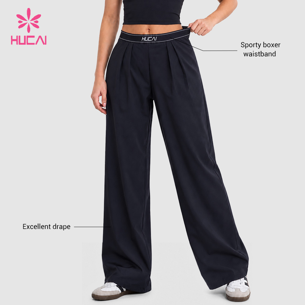 Custom navy wide leg baggy pants front view with elastic logo waistband detail