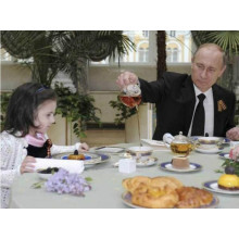 Putin entertained guests and pour tea for the children.