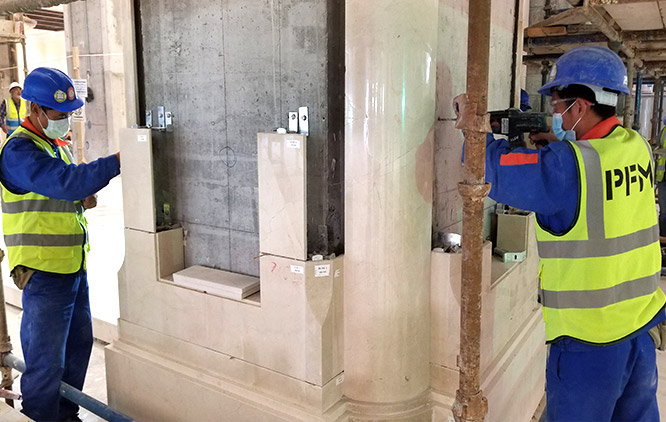 Installer fixing a marble panel on site