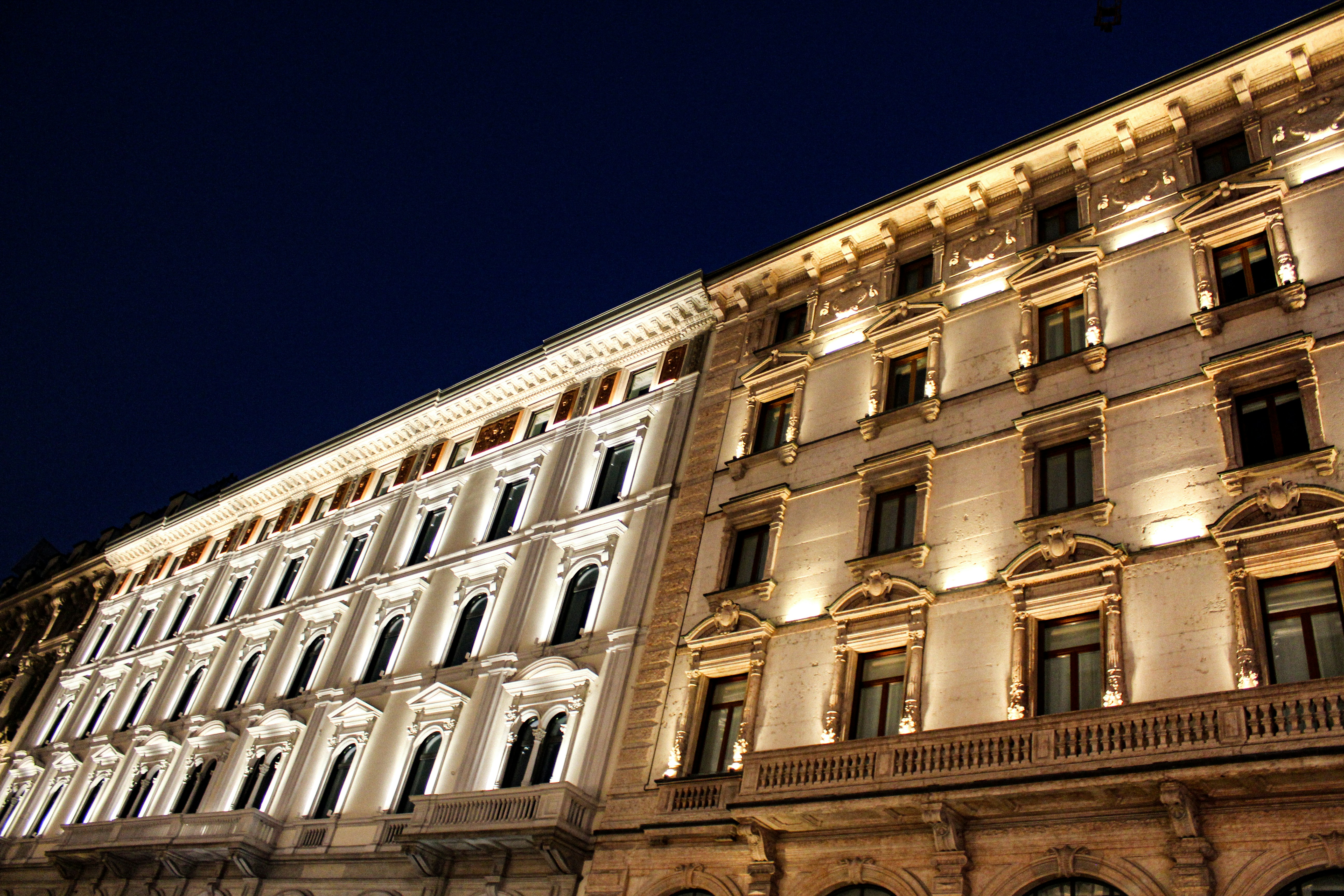 Facade of Milan Duomo glowing in the sunlight, showcasing its intricate Milano White Marble details.