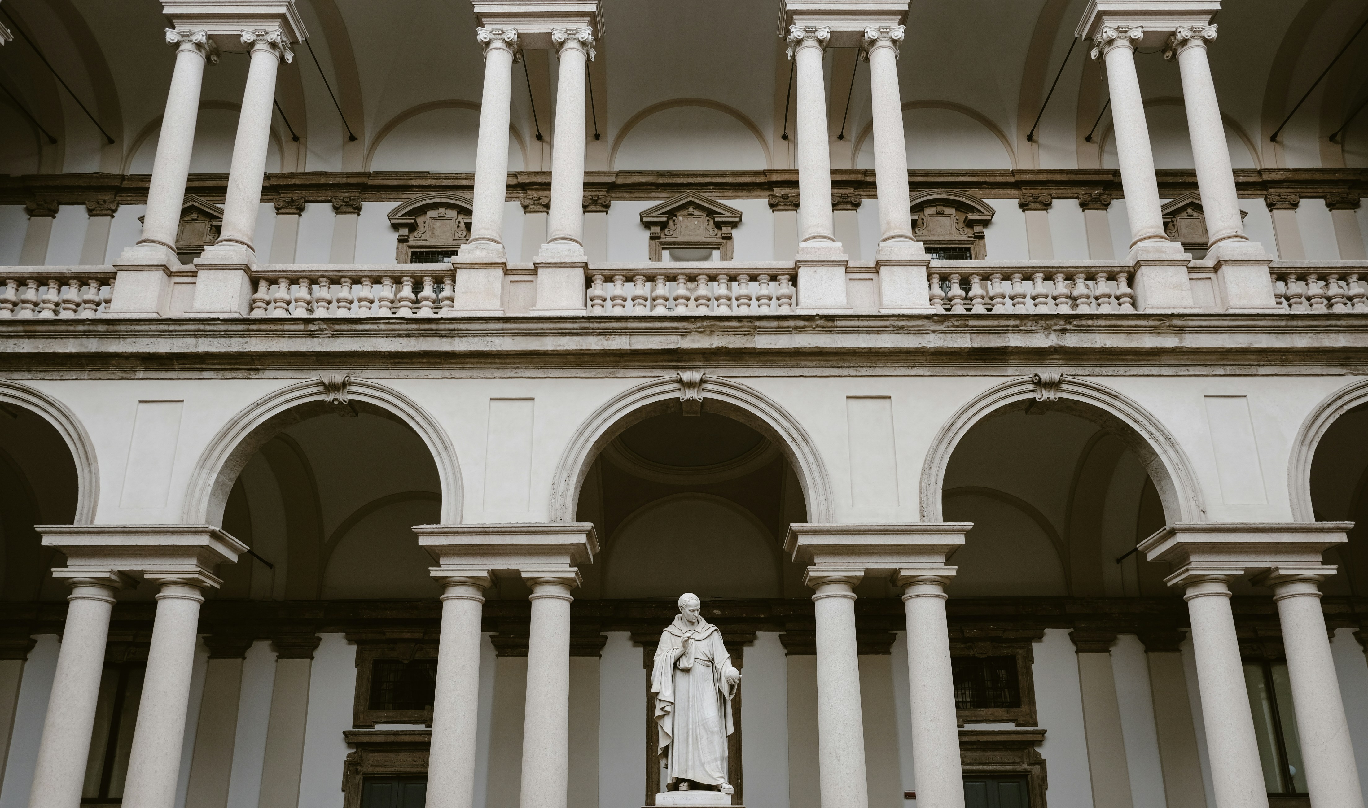 A slab of Milano White Marble showcasing its clean white background and subtle grey veining