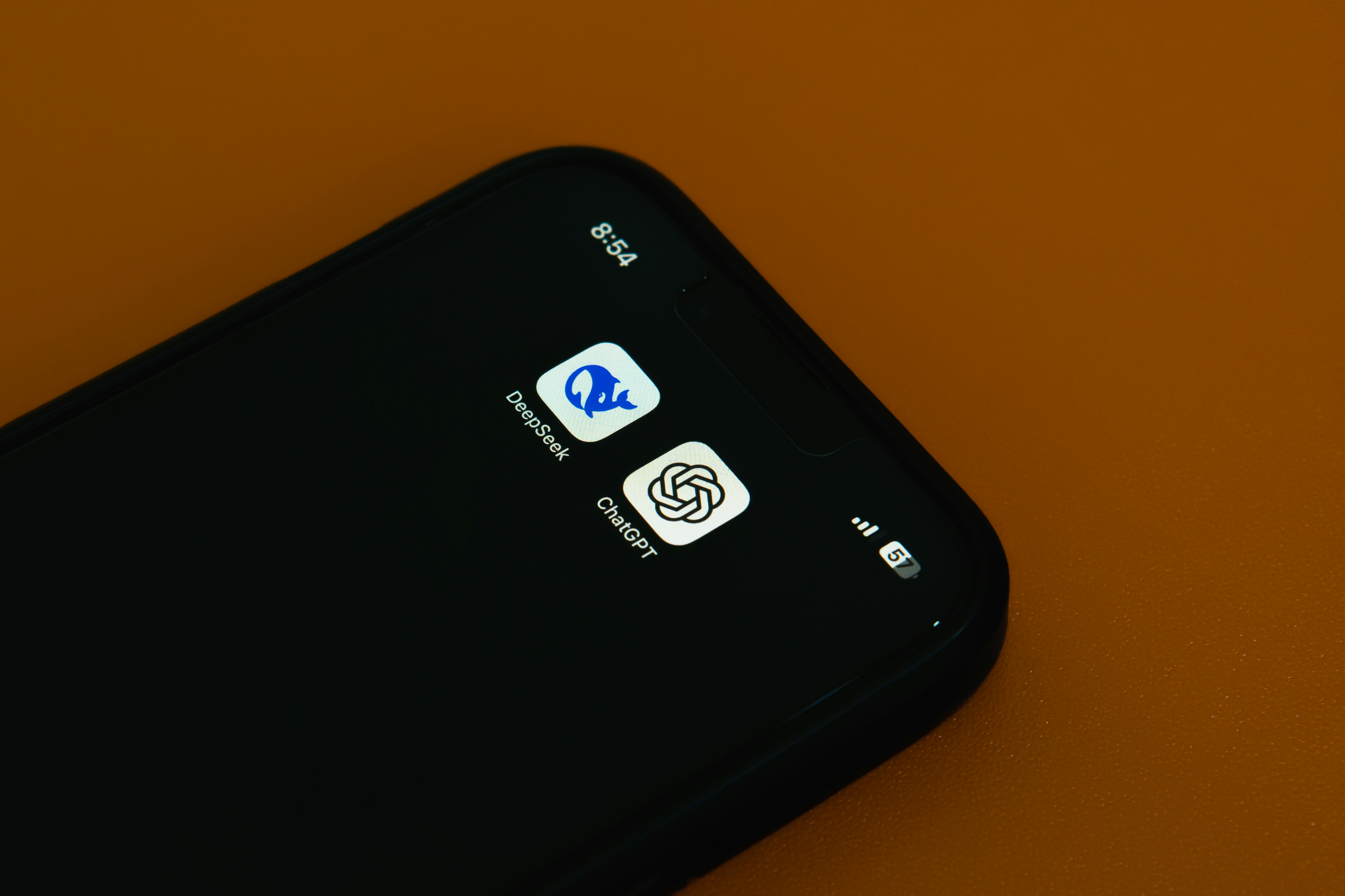 A Qi2 certified charger snapping onto the back of an Android phone, illustrating cross-device compatibility.