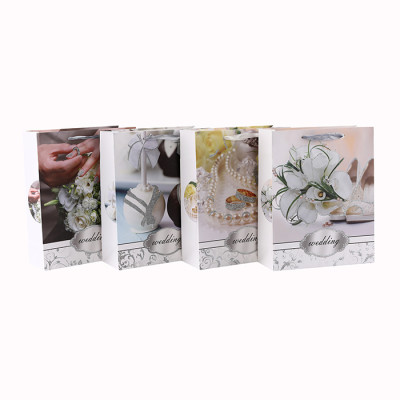 Sac en papier blanc de cadeau de paillettes de style romantique de fleur de carton avec 4 conceptions assorties dans l'emballage de Tongle
