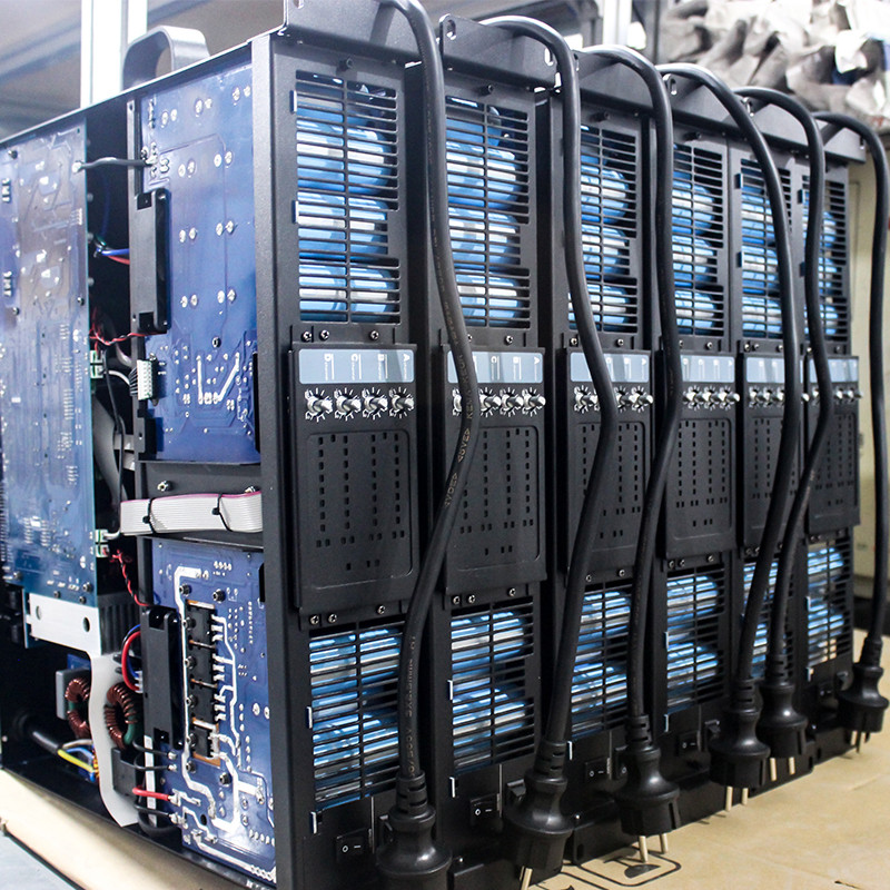 A close-up of a high-quality power supply unit inside a professional stage power amplifier.