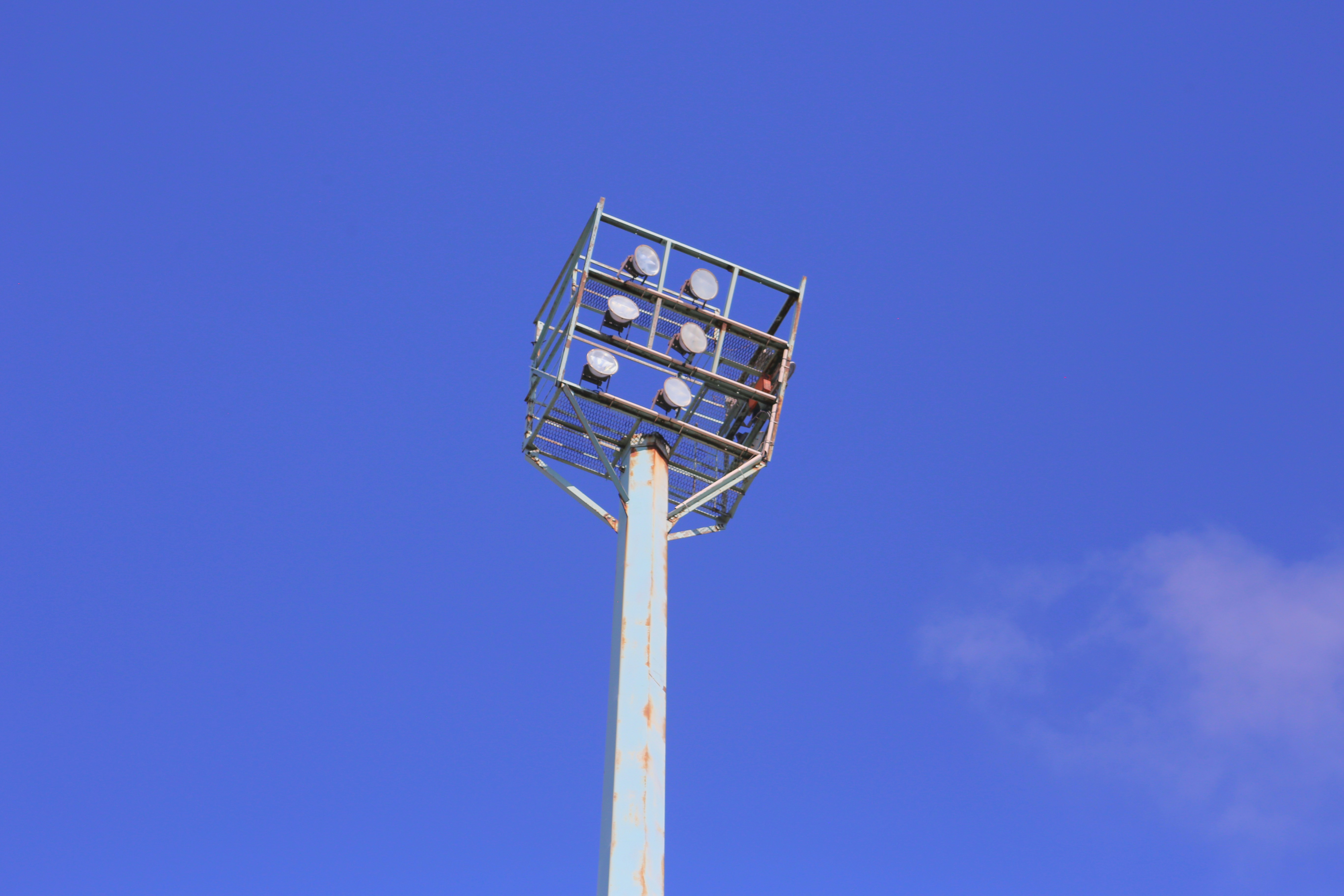 A weatherproof outdoor speaker installed on a stadium light pole