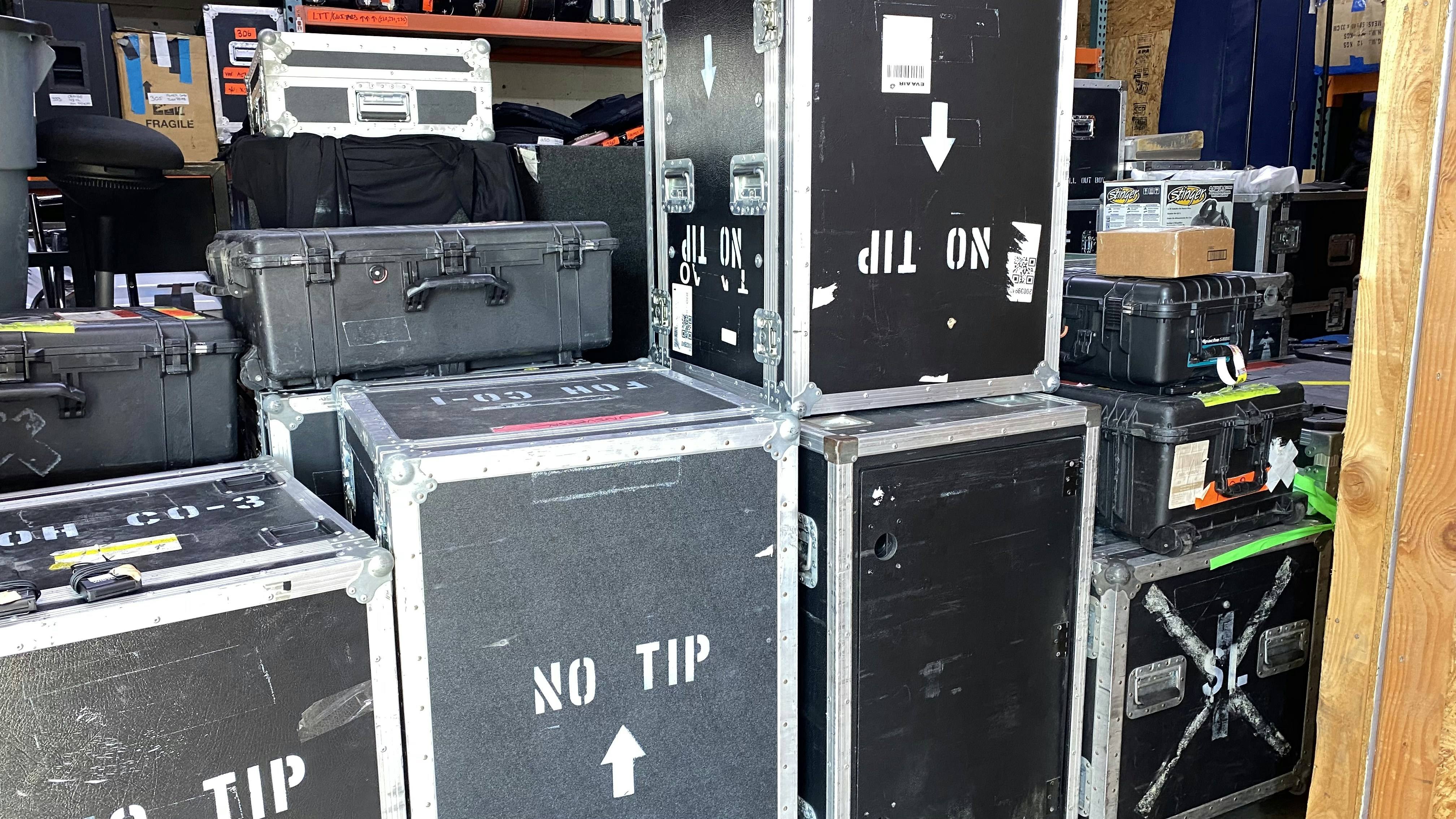 A collection of professional flight cases for sound equipment.