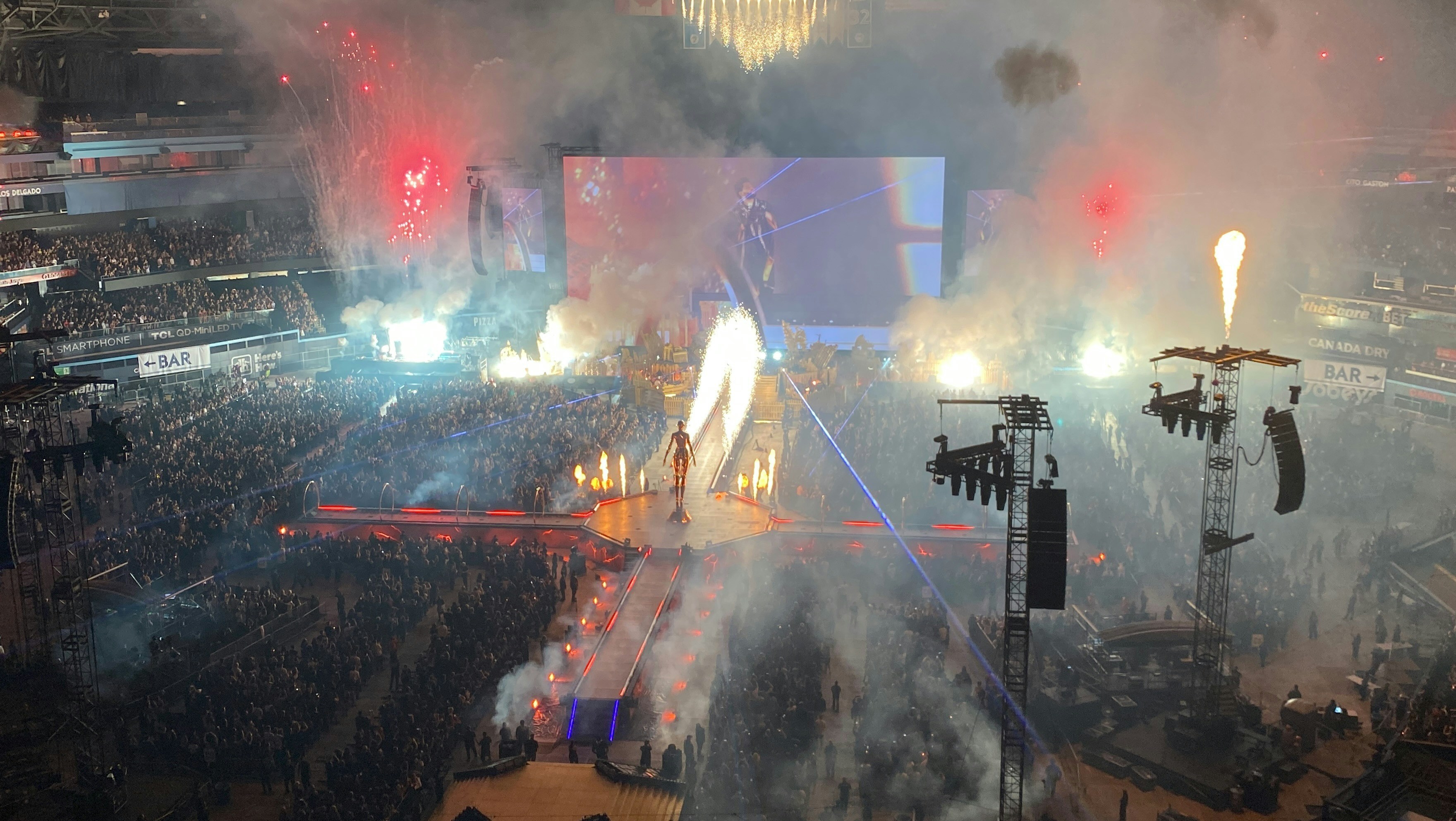 A massive flown passive Sinbosen line array system at a stadium concert, with the amplifier racks visible at the side of the stage.