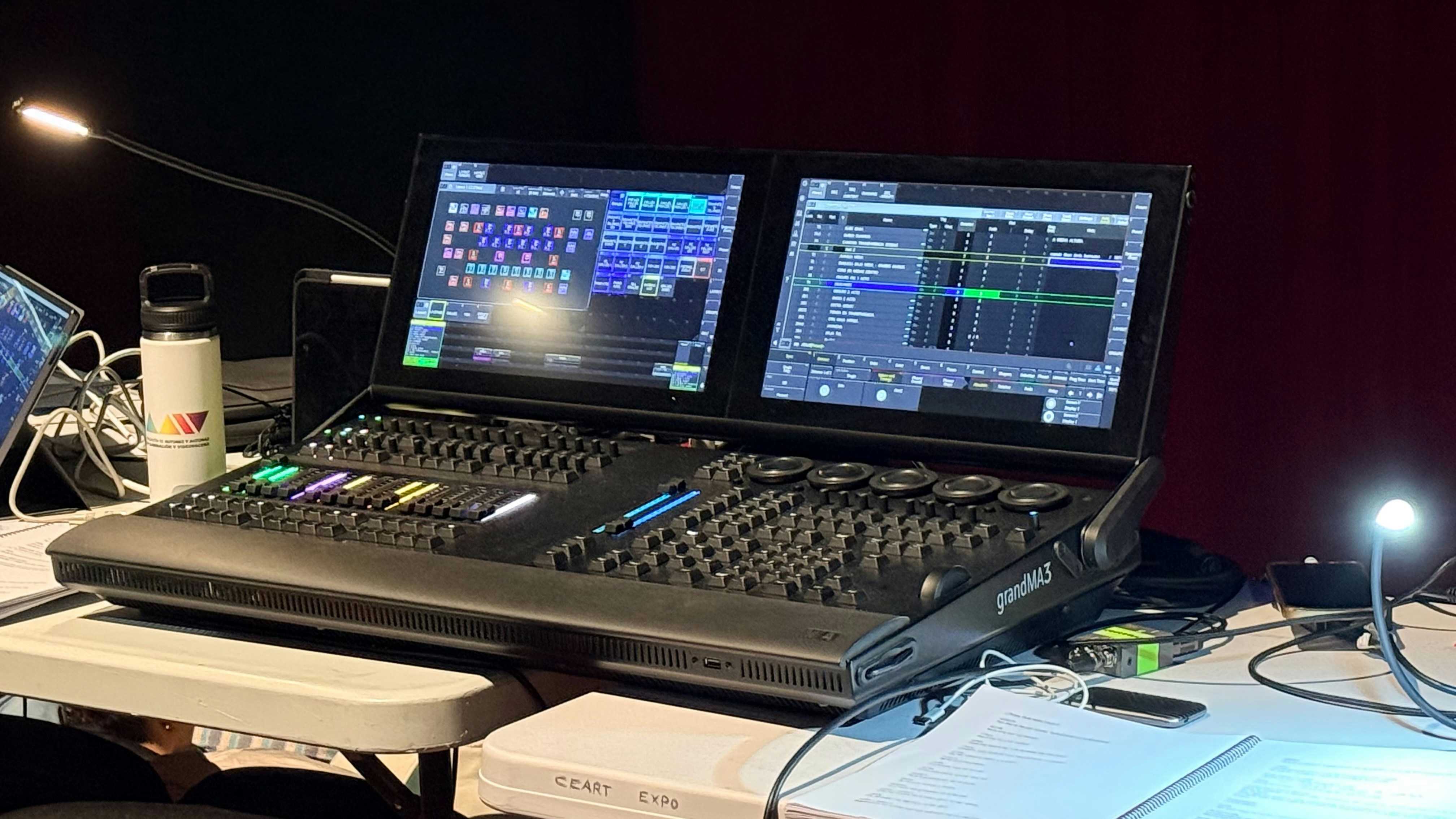 A wedge-style stage monitor on the floor of a stage, pointed towards where a performer would stand