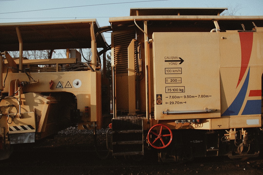 A portable standing seam roll forming machine on a trailer at a construction site.