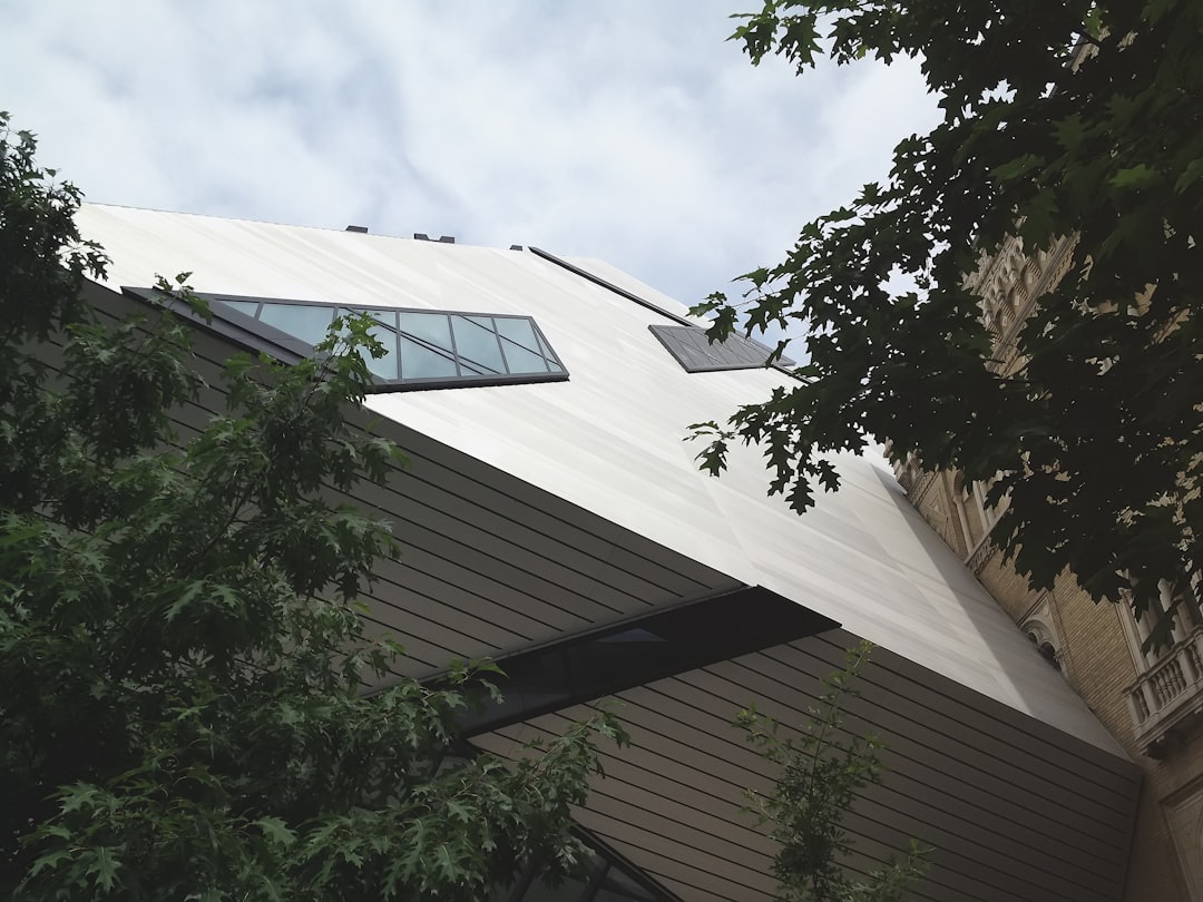 A sleek, modern building with a newly installed standing seam metal roof