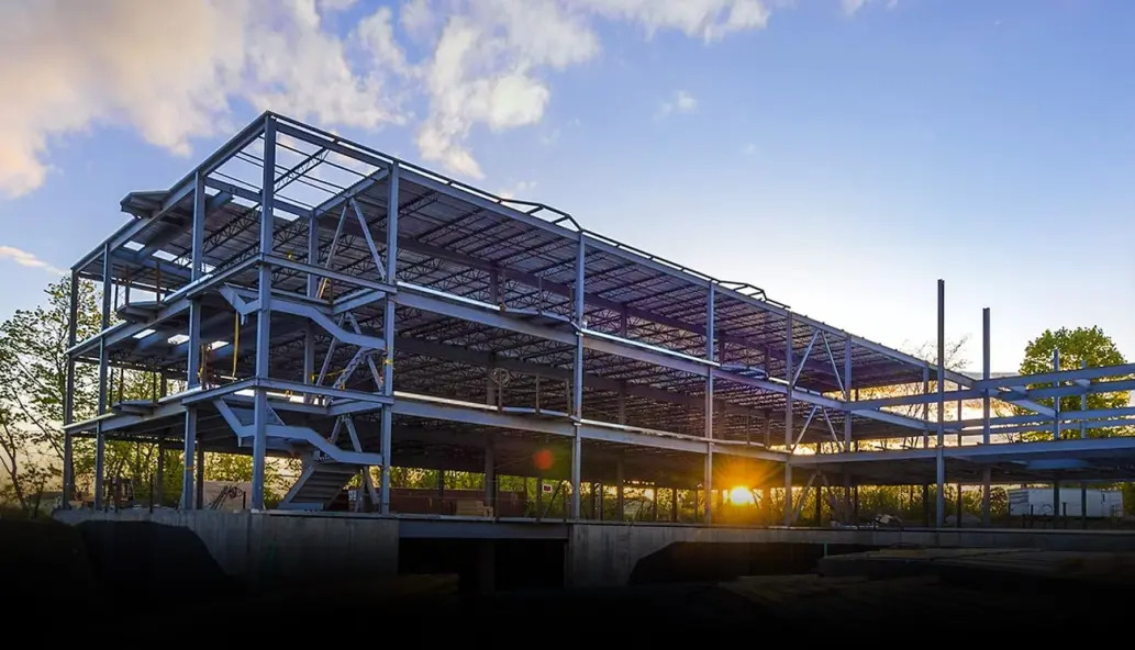 What type of steel is used in the construction of Prefab light steel structure warehouse building?
