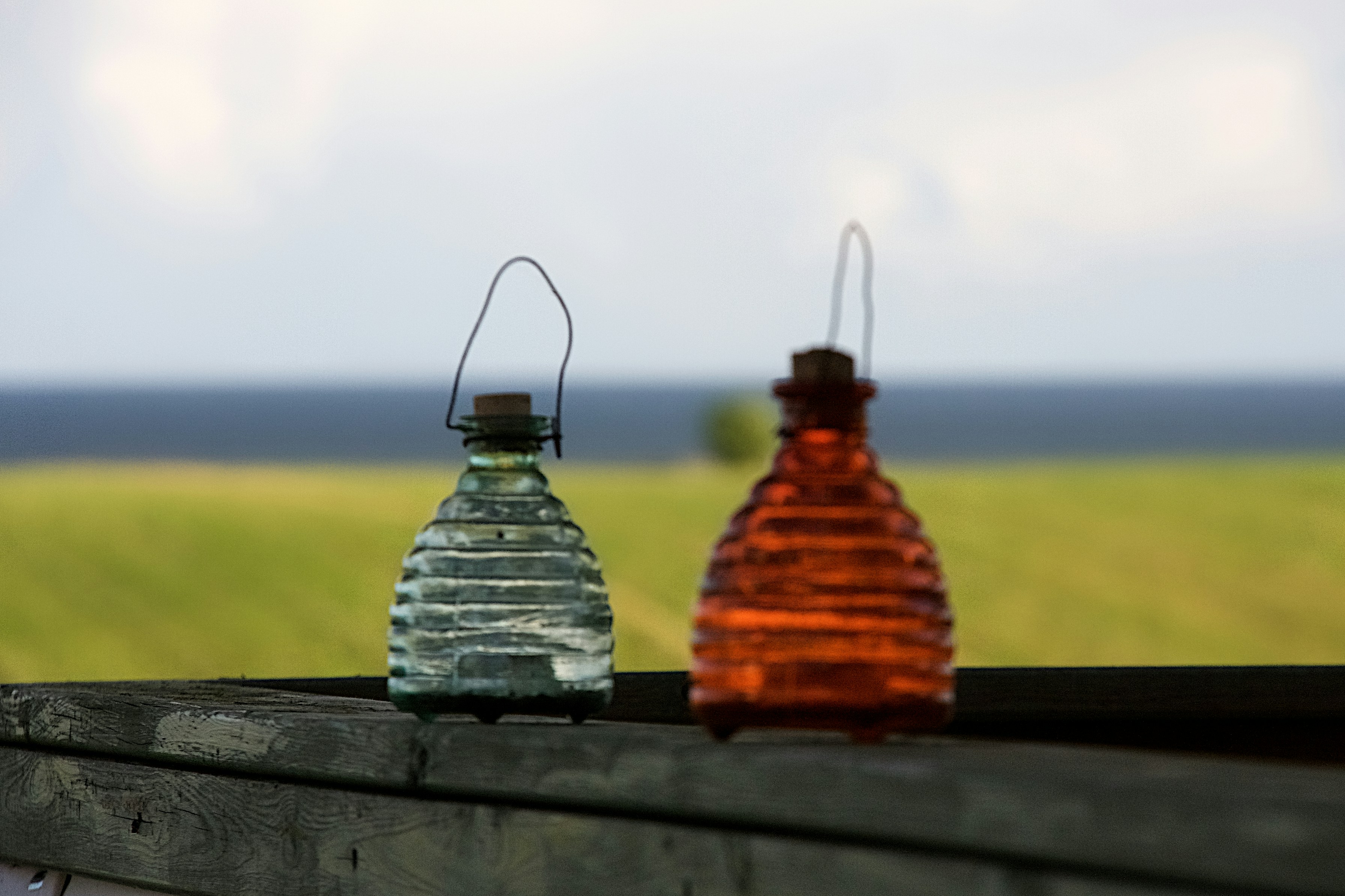 A collection of eco-friendly perfume bottles made from recycled glass and with wooden caps
