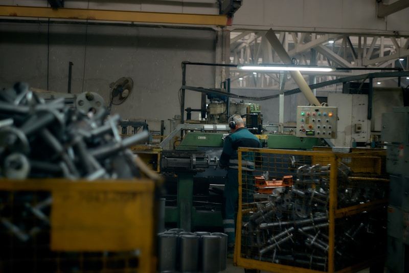 Worker operating machinery in aluminized steel production facility - MESCO Steel
