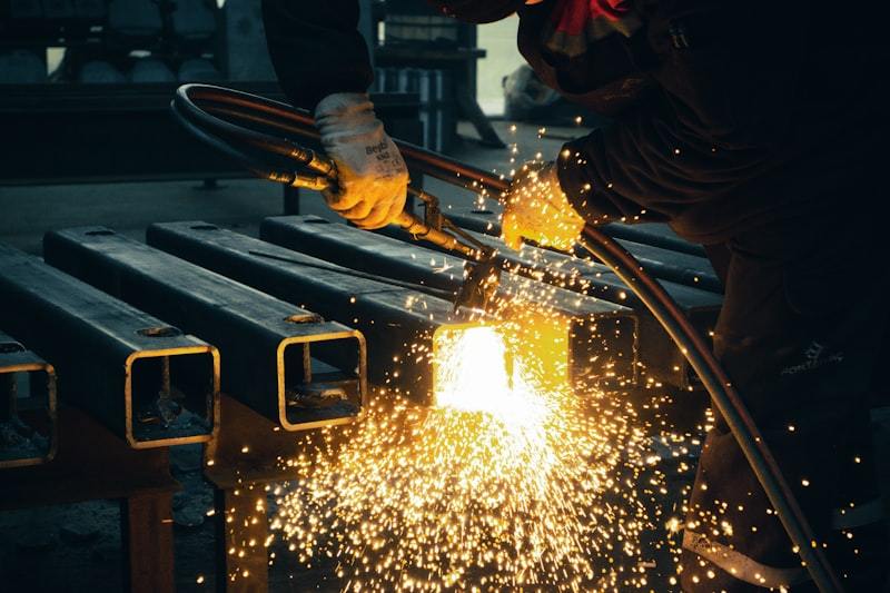 Welder working on steel pipe production with high-frequency welding system