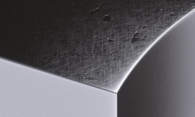Close up of powder coated metal surface with water droplets showing protective coating quality