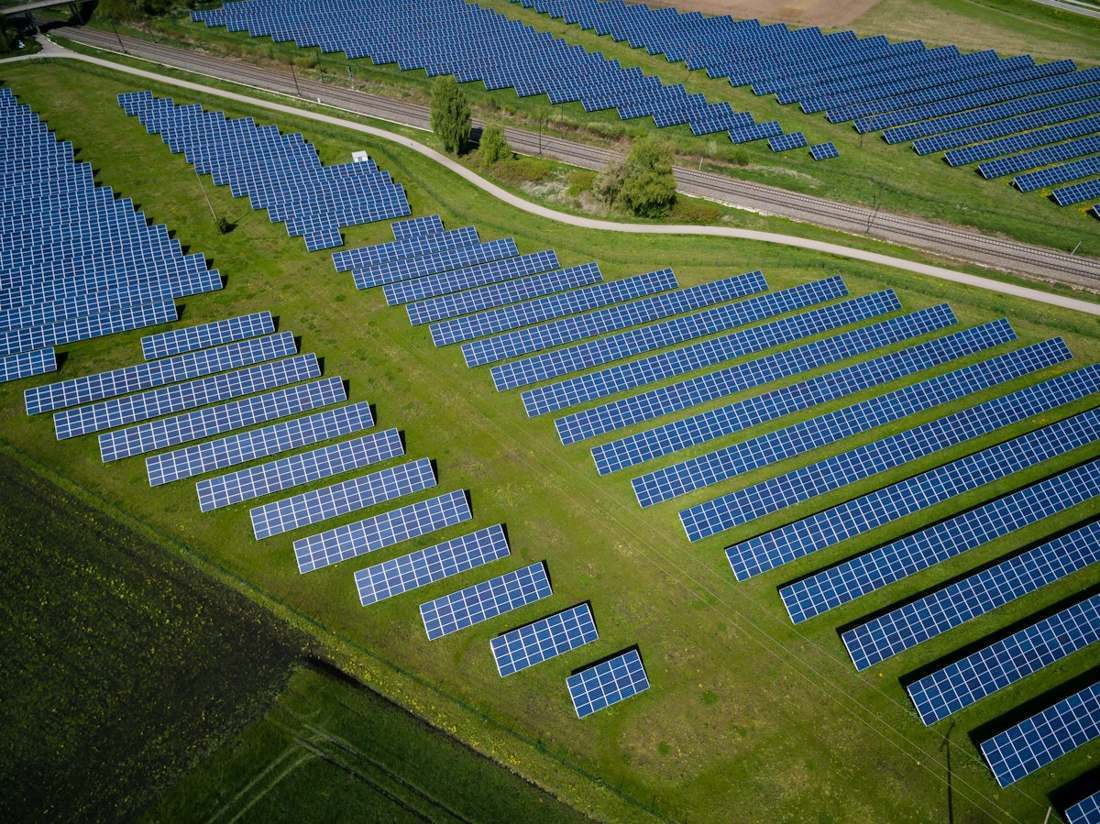 Aerial view of a large solar farm with steel mounting structures