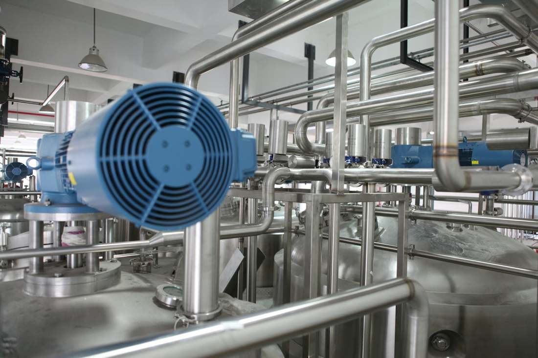 Industrial stainless piping and valves inside a process plant