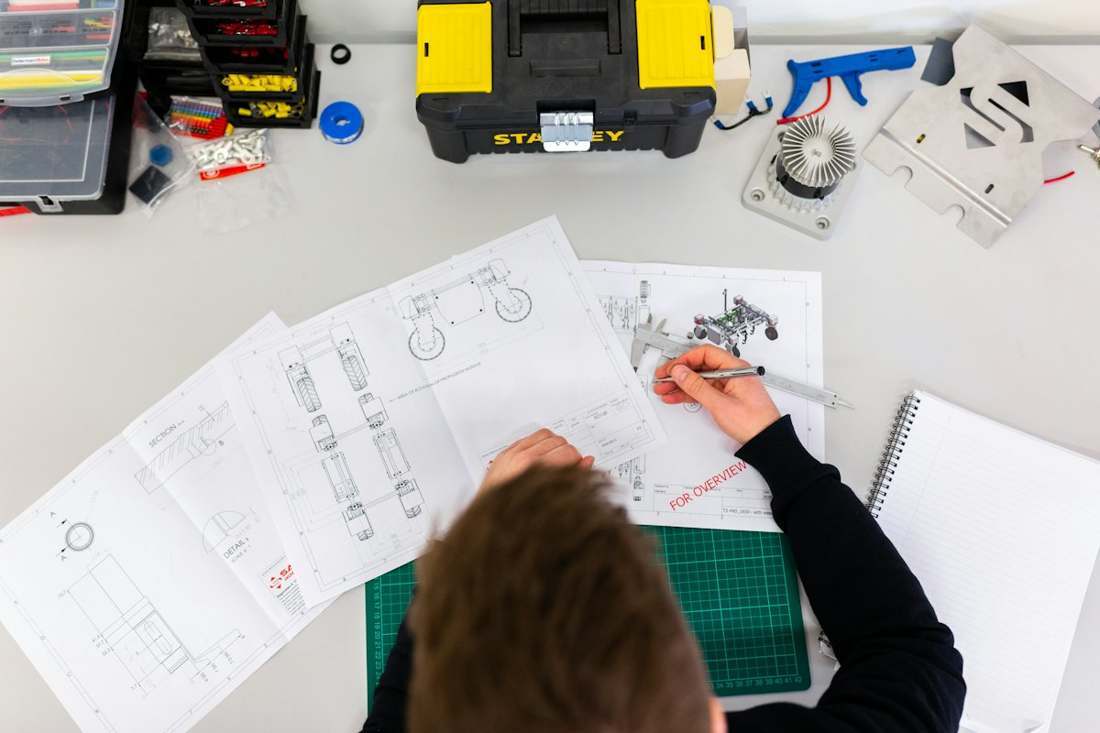 Engineer reviewing technical drawings at a workbench