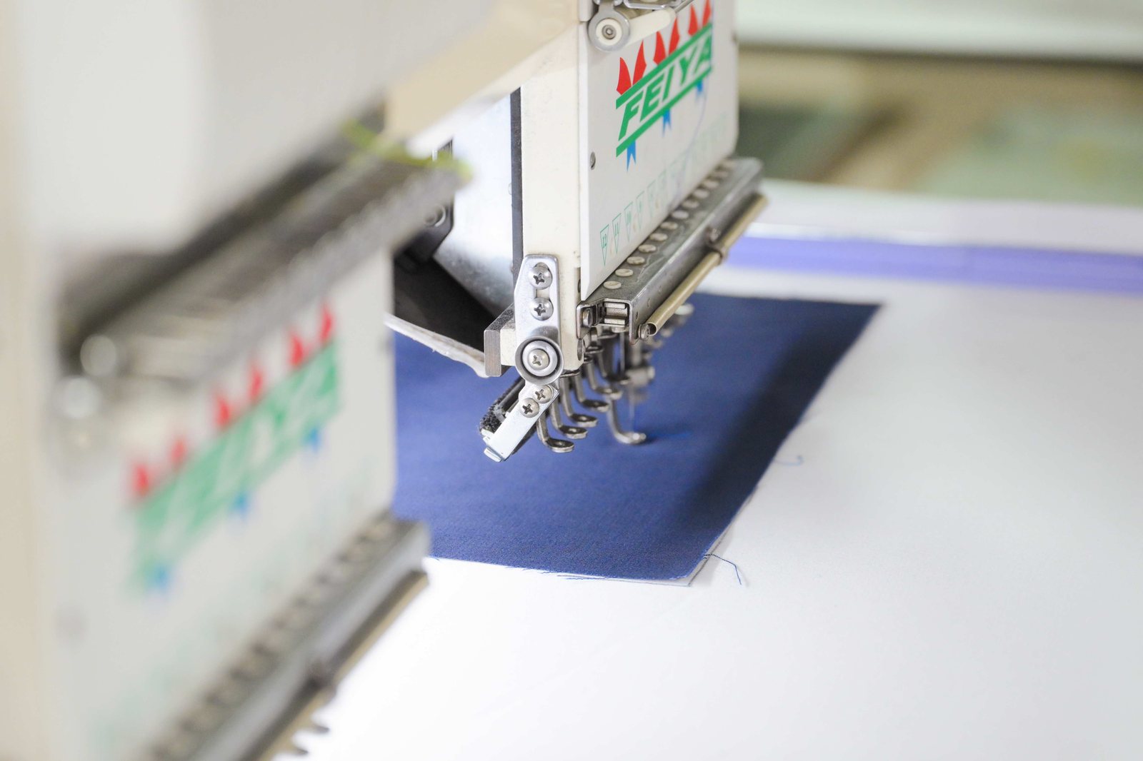 Close-up of a sewing needle stitching fabric