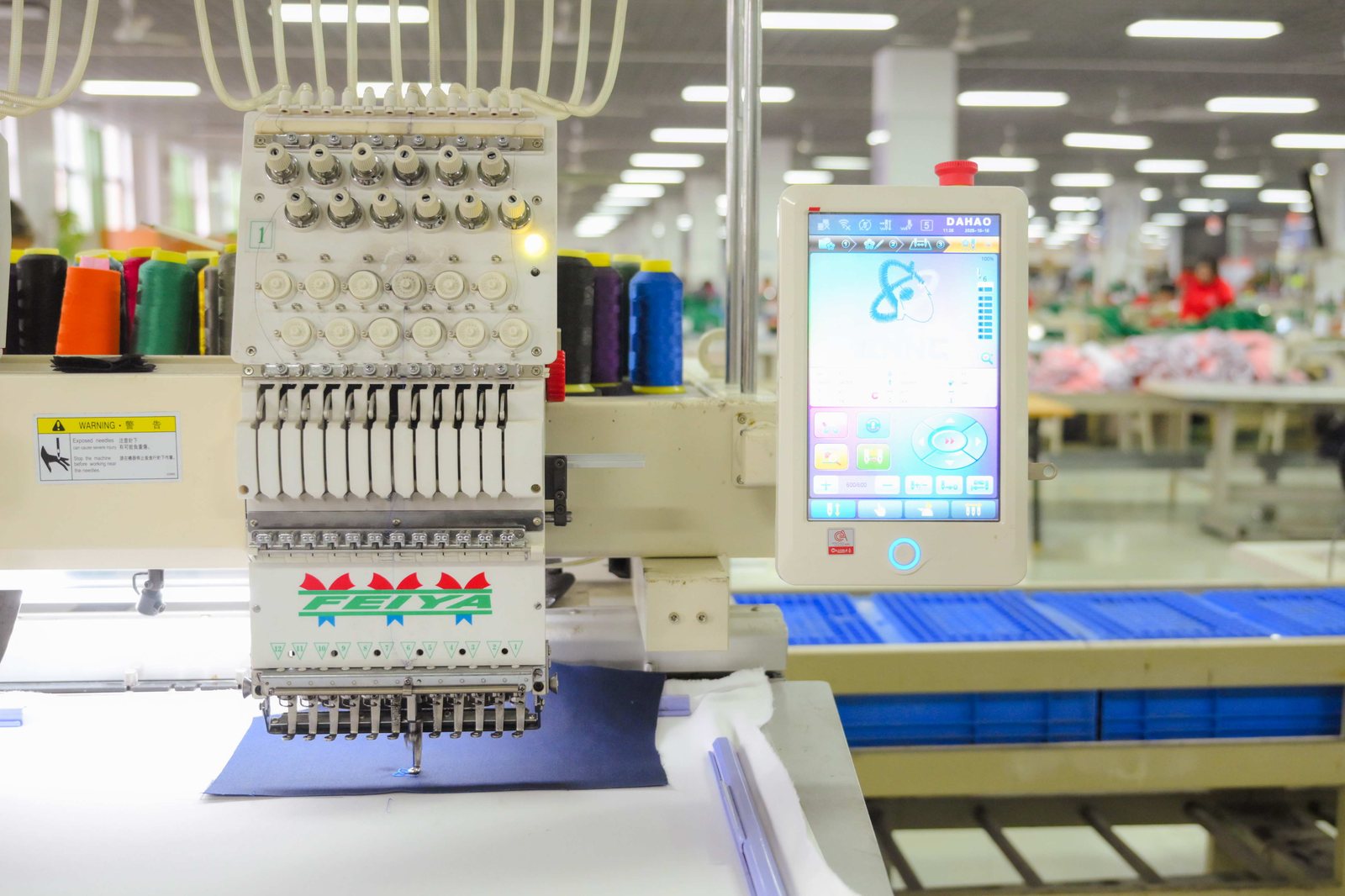 Multi-head embroidery machine working on fabric