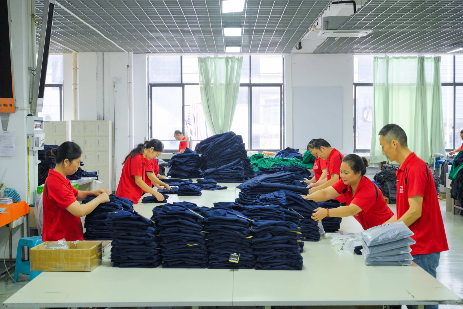 Dark workwear garments sorted on the finishing table