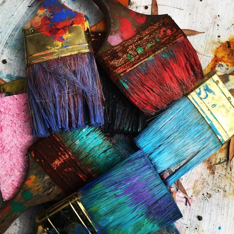Artist painting with acrylic colours on canvas