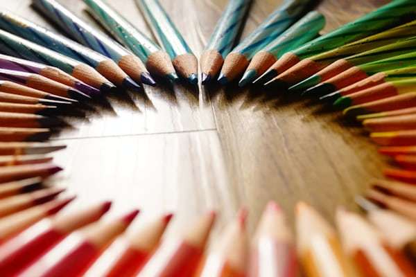 Colored pencil set arranged in circle showing full color range
