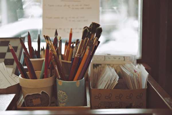 Art supplies with colored pencils in containers ready for distribution