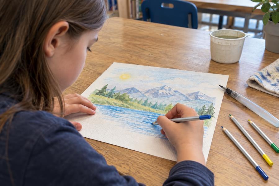 Students creating colorful artwork with water-soluble pencils