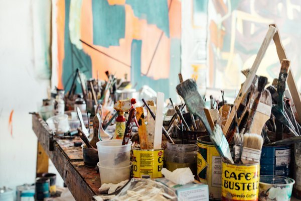 Studio workbench with brushes and paint containers