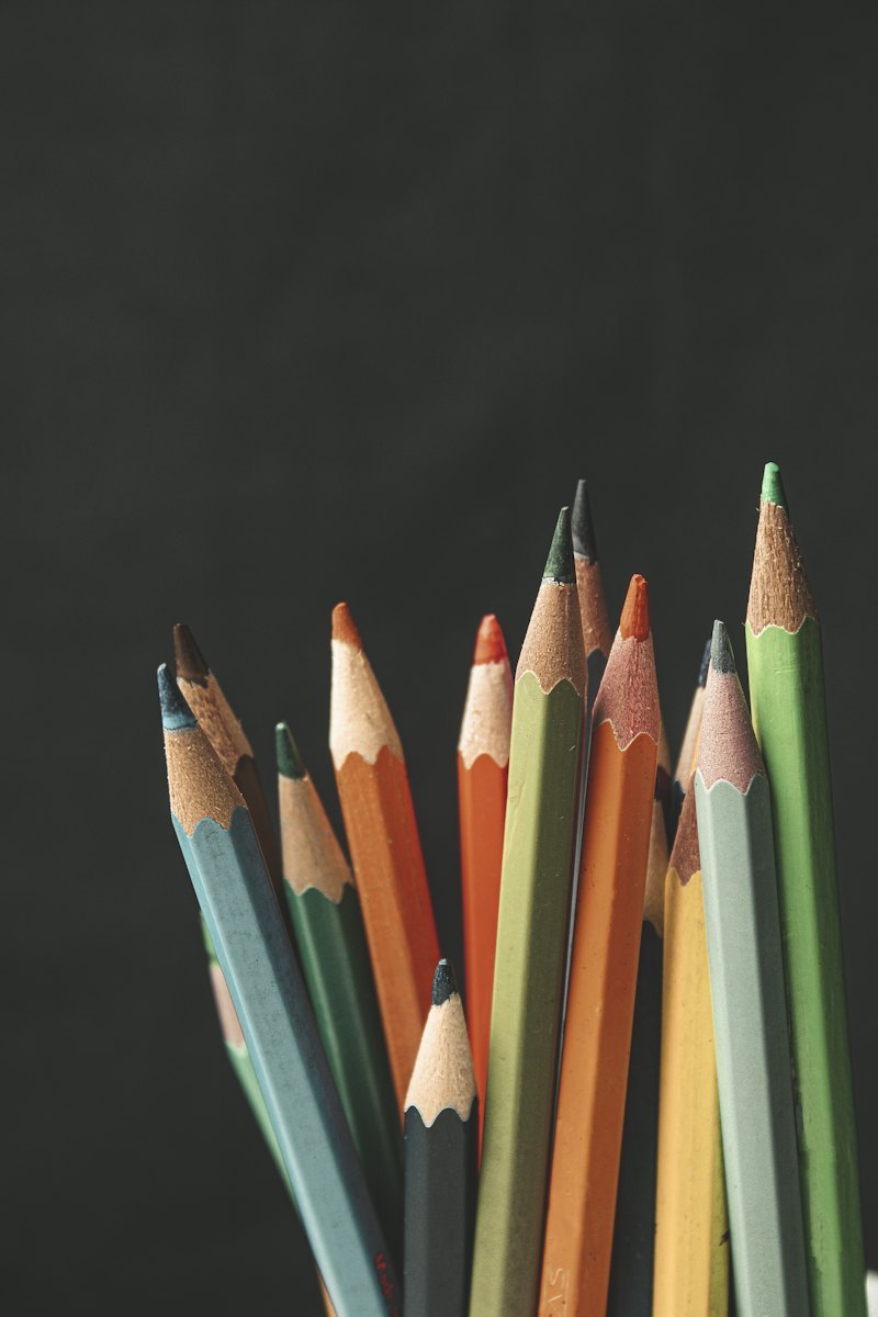 Bundle of sharpened colored pencils on a dark surface