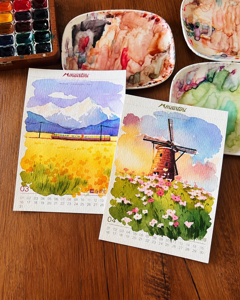 Watercolor palette and finished landscape artworks