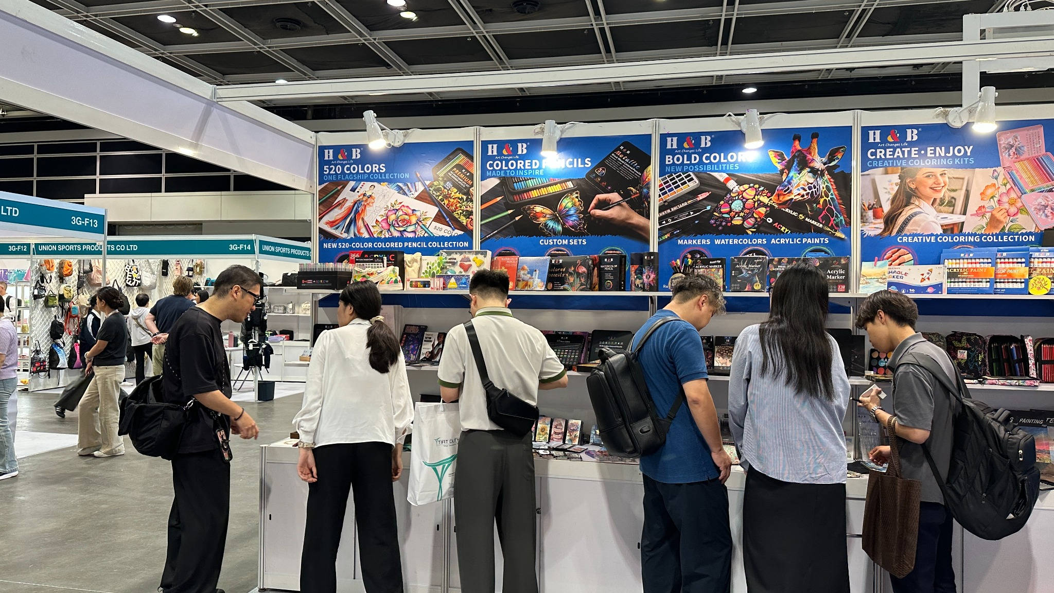 Visitors examining H&B Art product displays at the MEGA SHOW 2026 booth