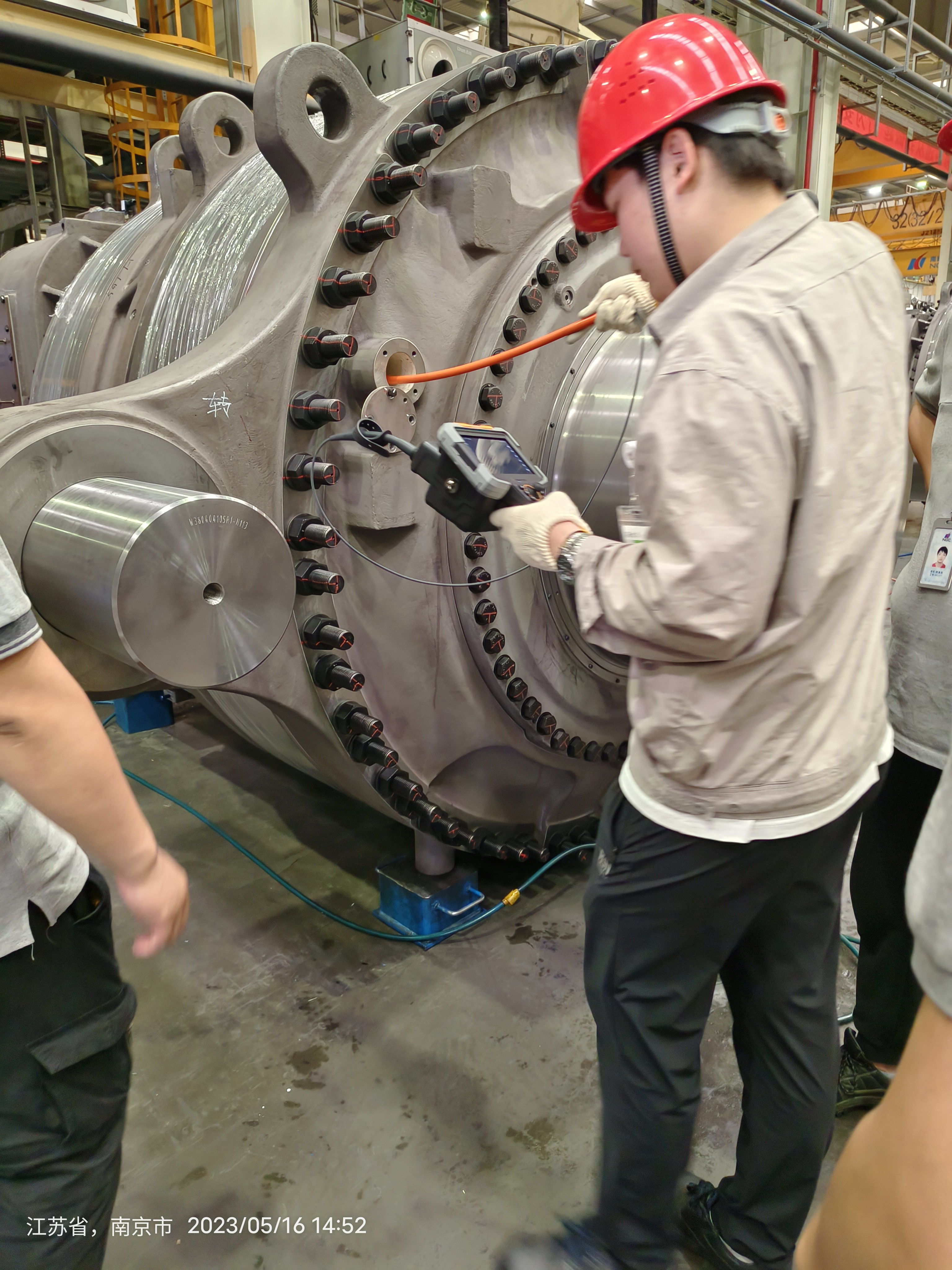 Ultra-realistic industrial inspection scene inside a large mechanical gearbox, technician using a videoscope, cinematic lighting
