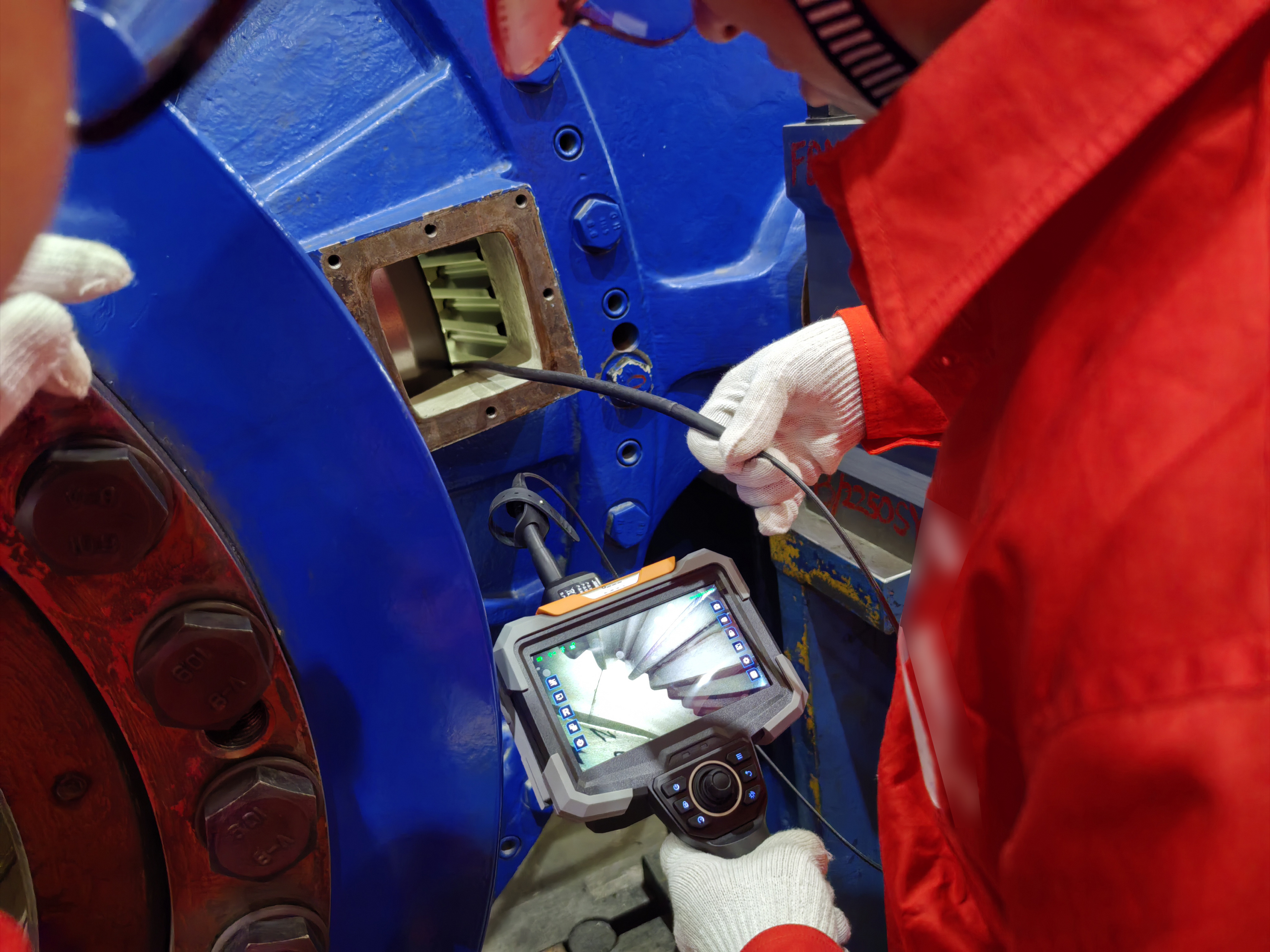 Technician using JEET videoscope to inspect gearbox with safety gear