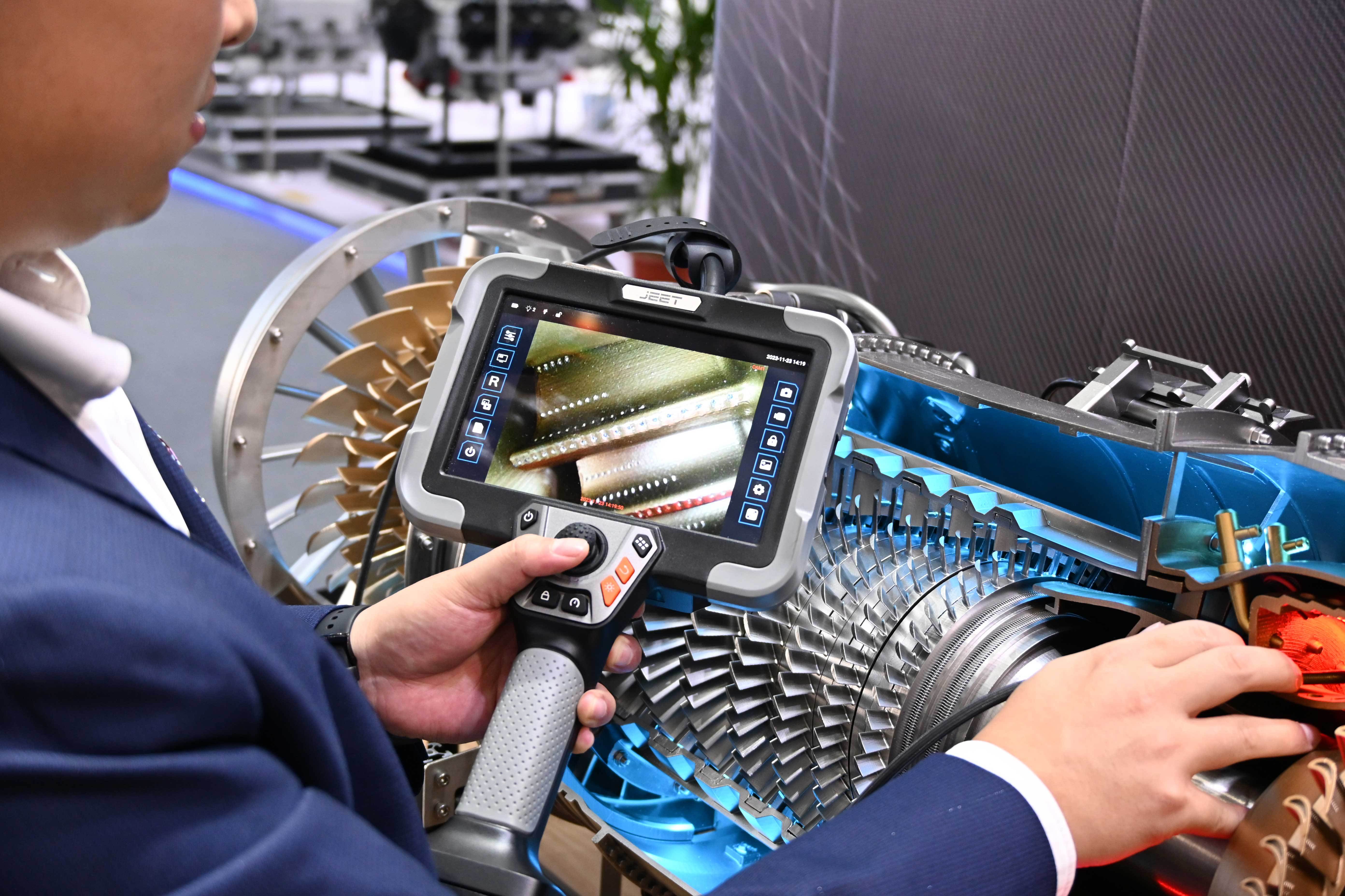 Technician using ultra-thin videoscope in helicopter engine inspection