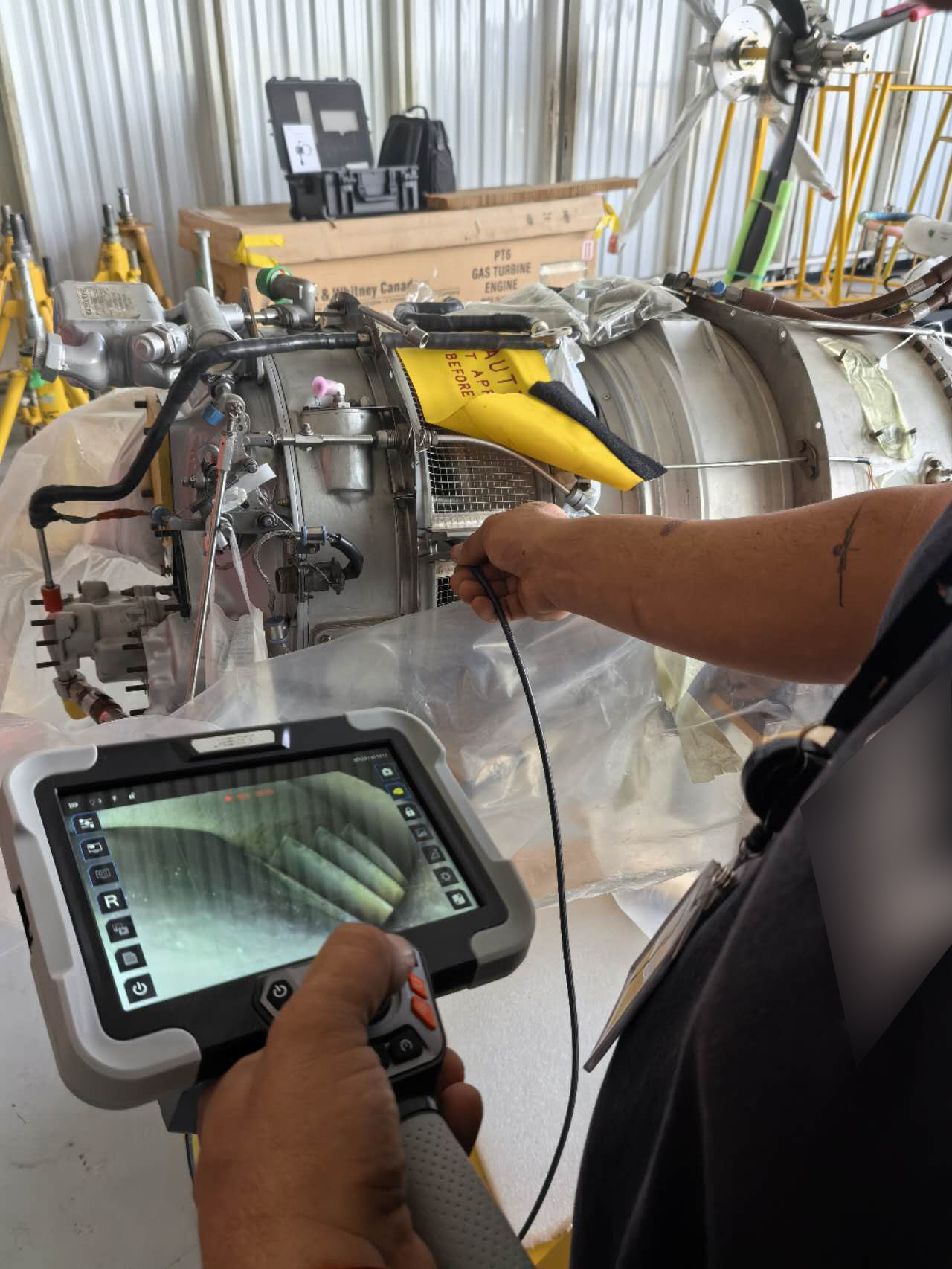 JX series borescope probe being inserted into turbofan engine borescope port for HPT blade inspection