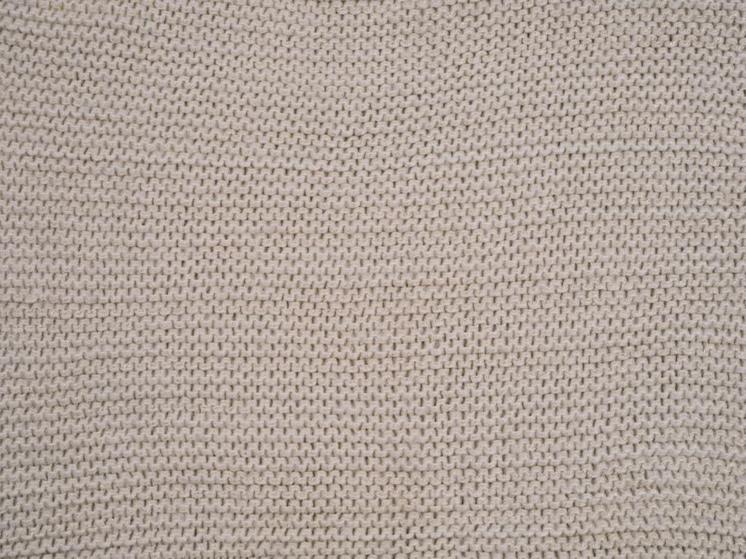Close-up of fine white cashmere knit texture showing fiber quality