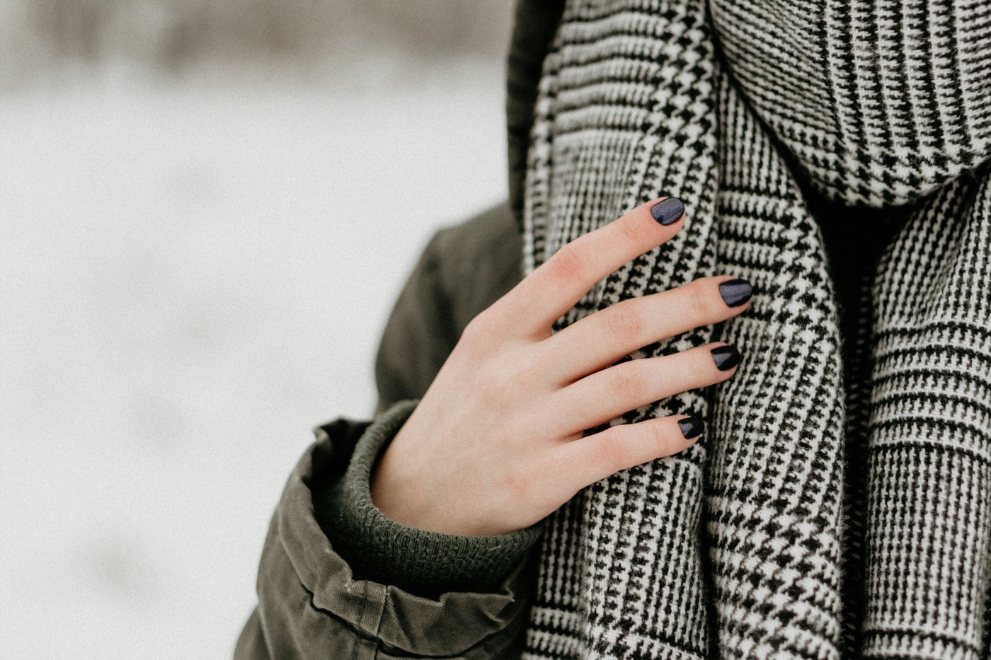 Close-up of a houndstooth cashmere scarf, showing the texture and weight that determines its hand feel