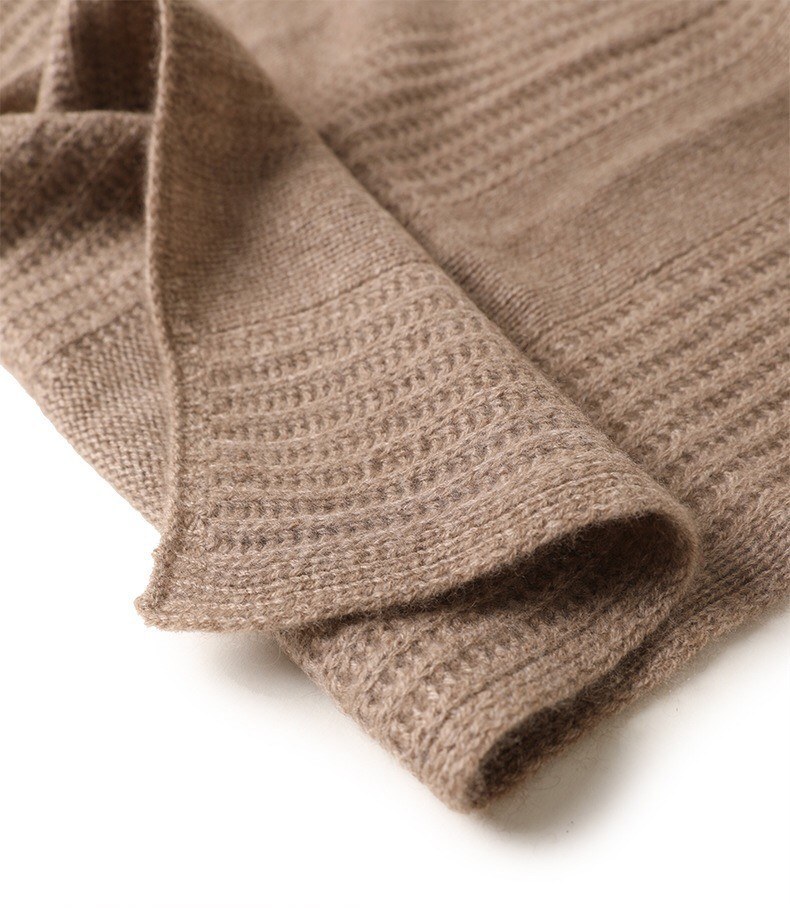 Close macro detail of the raised waffle knit structure on a camel cashmere throw