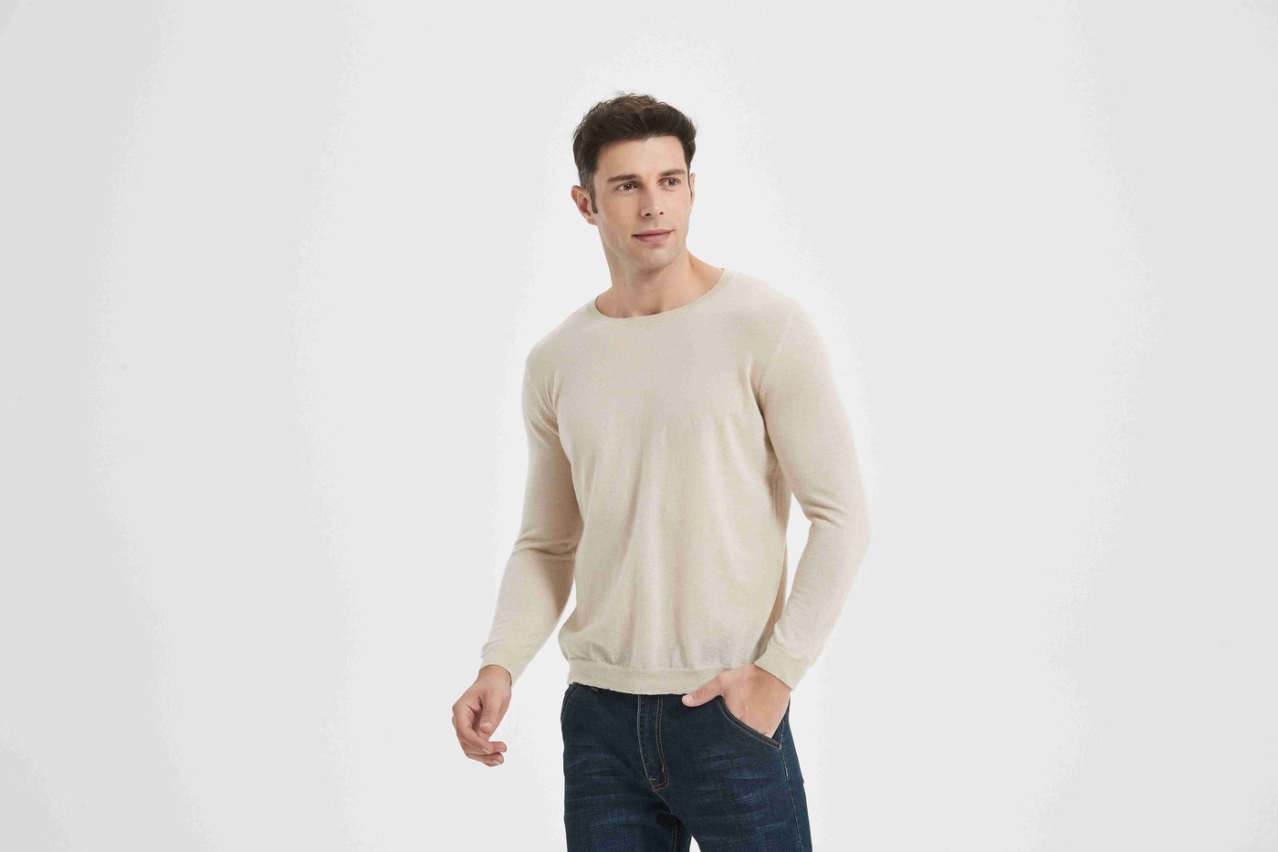 Close view of an oatmeal cashmere crew-neck sweater showing even stitch structure at the chest and shoulder