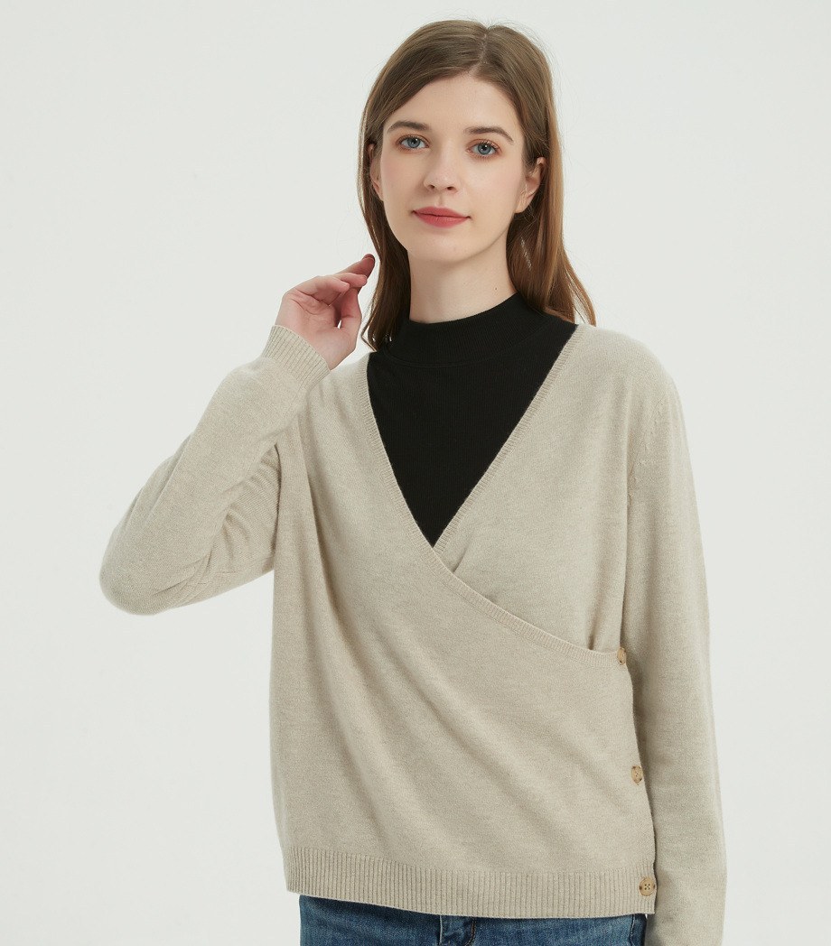 Full view of the beige undyed cashmere wrap sweater worn with jeans