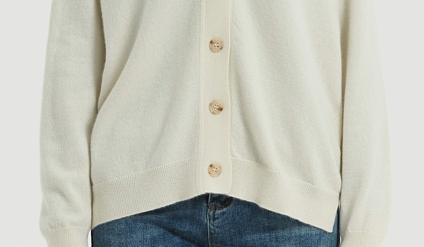 Close view of a cream cashmere knit showing compact, even stitch structure