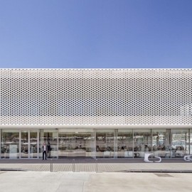 The façade of carpark with perforated vertical metal facade for balconies and parapets