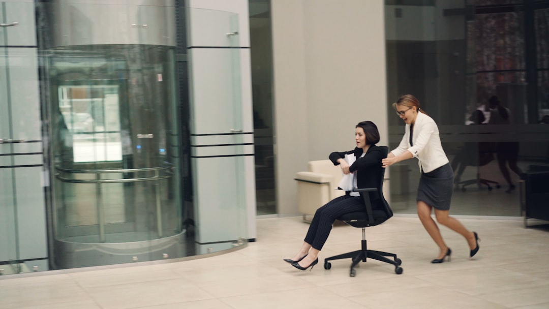 A person easily pulling an old caster out of an office chair base