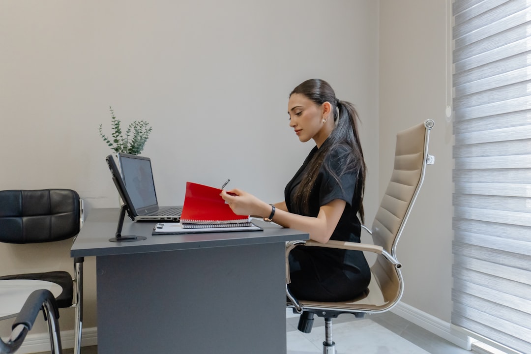 A person sitting with correct posture in an ergonomic office chair